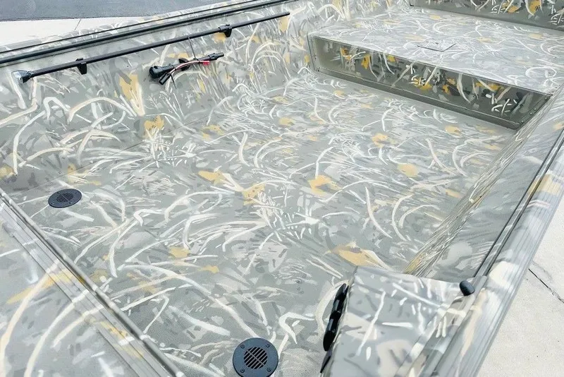 Slide: The Image of 2026 War Eagle 648LDV boat interior with camouflage design and seating area. - 4