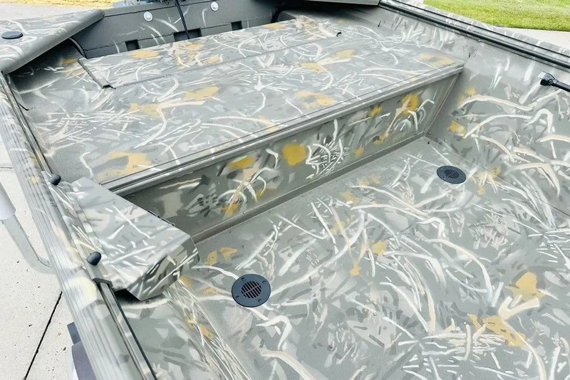 Slide: The Image of 2026 War Eagle 648LDV boat interior with camouflage pattern and storage compartments. - 5