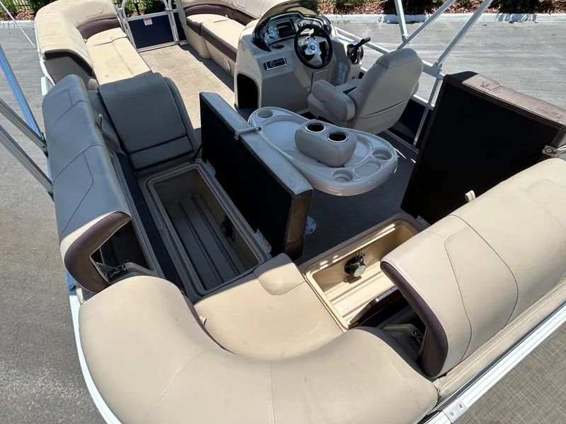 Slide: The Image of 2018 Sun Tracker Party Barge 20 DLX interior with seating and storage compartments. - 11