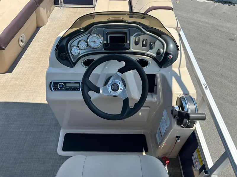 Slide: The Image of 2018 Sun Tracker Party Barge 20 DLX dashboard with steering wheel and controls. - 9