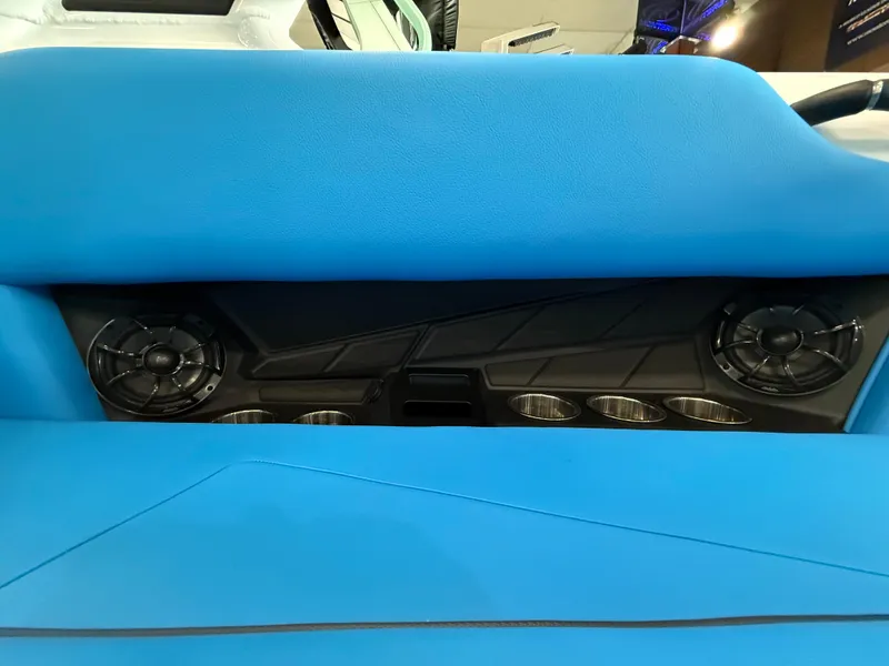 Slide: The Image of 2025 Moomba Tykon interior with blue seating, speakers, and cup holders. - 14