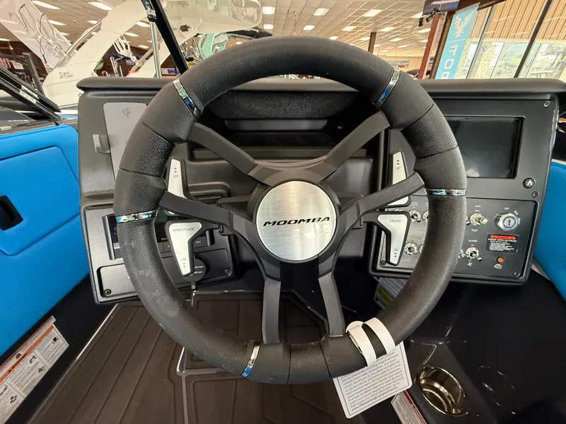 Slide: The Image of 2025 Moomba Tykon steering wheel and dashboard with control features. - 18