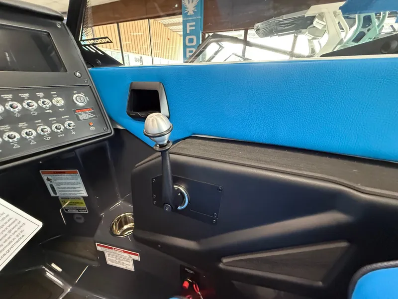 Slide: The Image of 2025 Moomba Tykon boat interior with control panel and blue upholstery. - 21