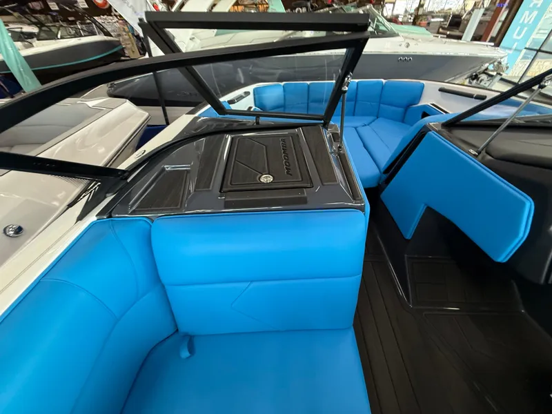 Slide: The Image of 2025 Moomba Tykon boat interior with vibrant blue seating and sleek design. - 22