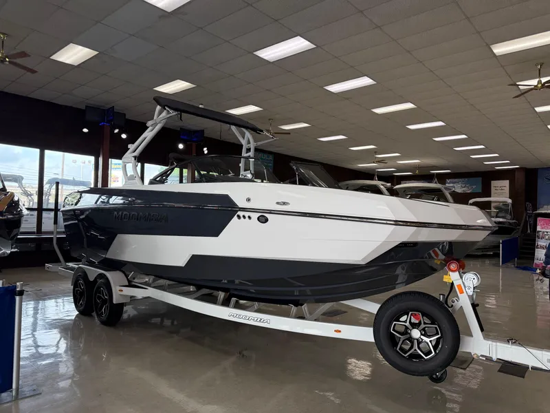 Slide: The Image of 2025 Moomba Tykon boat displayed indoors on a trailer. - 4