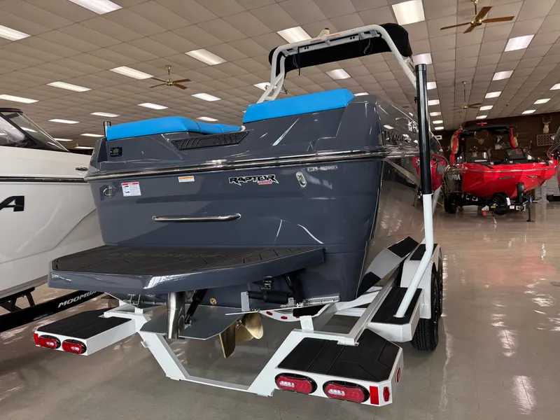 Slide: The Image of 2025 Moomba Tykon boat in showroom, featuring sleek design and Raptor engine. - 5