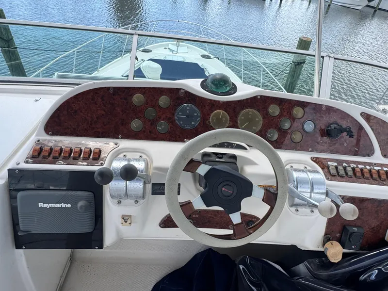 Slide: The Image of Cockpit of 1998 Maxum 4600 SCB yacht with steering wheel and control panel. - 11