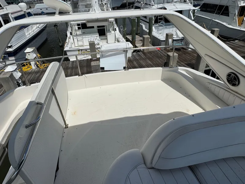 Slide: The Image of Spacious deck of 1998 Maxum 4600 SCB yacht docked at marina. - 13