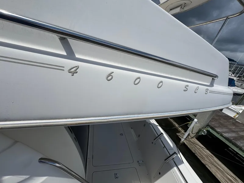 Slide: The Image of 1998 Maxum 4600 SCB yacht docked, showcasing sleek design and model details. - 14
