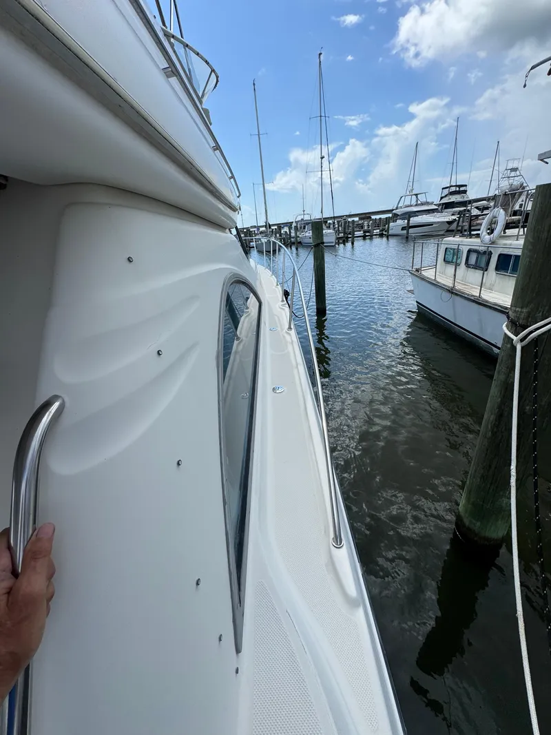 Slide: The Image of Side view of a 1998 Maxum 4600 SCB yacht docked at a marina. - 18