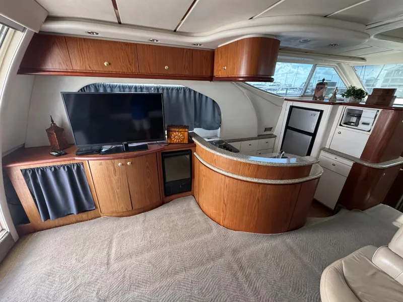Slide: The Image of Luxurious interior of 1998 Maxum 4600 SCB yacht with modern amenities and elegant wood finishes. - 19