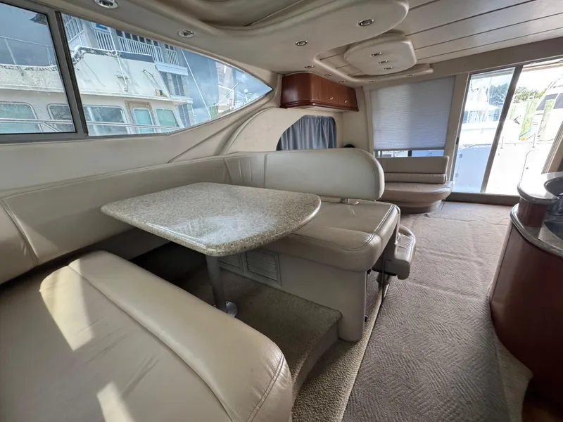 Slide: The Image of Interior of 1998 Maxum 4600 SCB yacht with beige seating and granite table. - 21