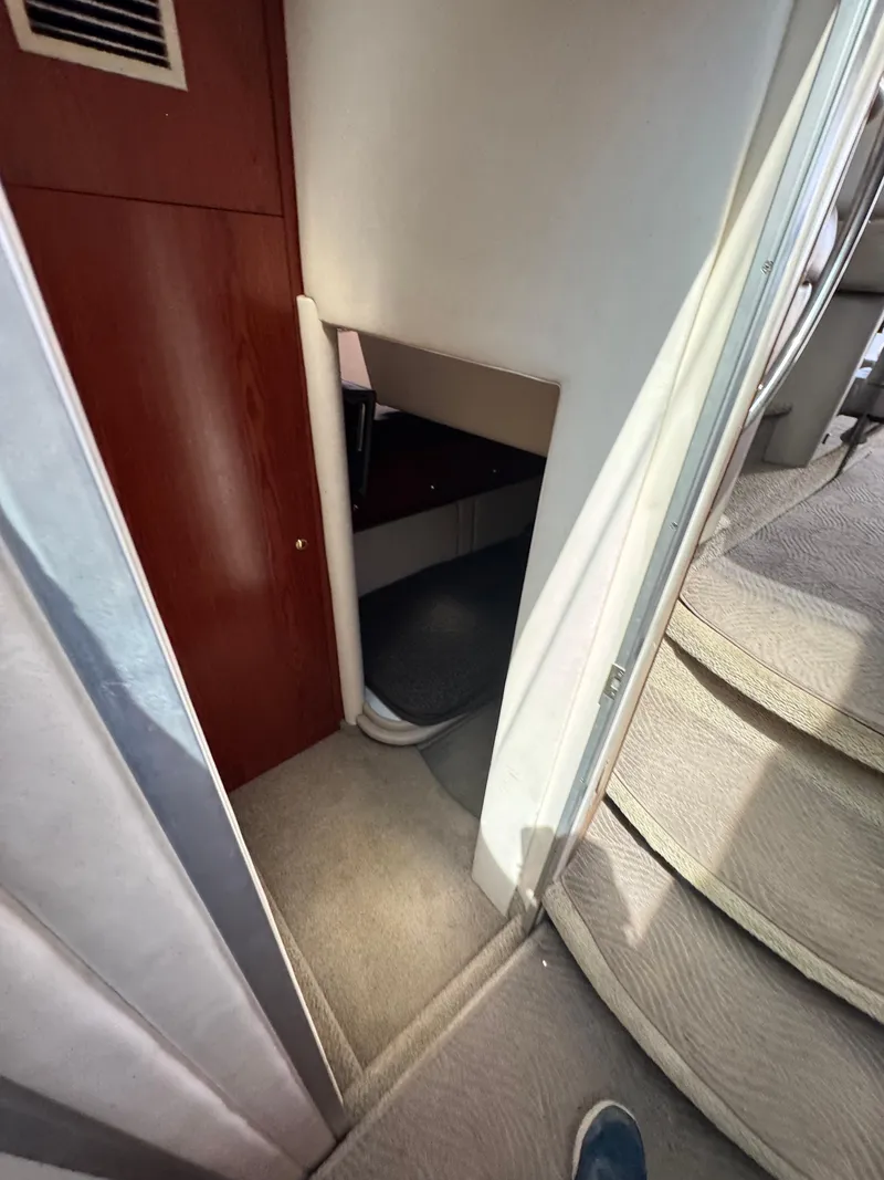 Slide: The Image of Interior view of 1998 Maxum 4600 SCB yacht, featuring stairs and a small cabin space. - 23