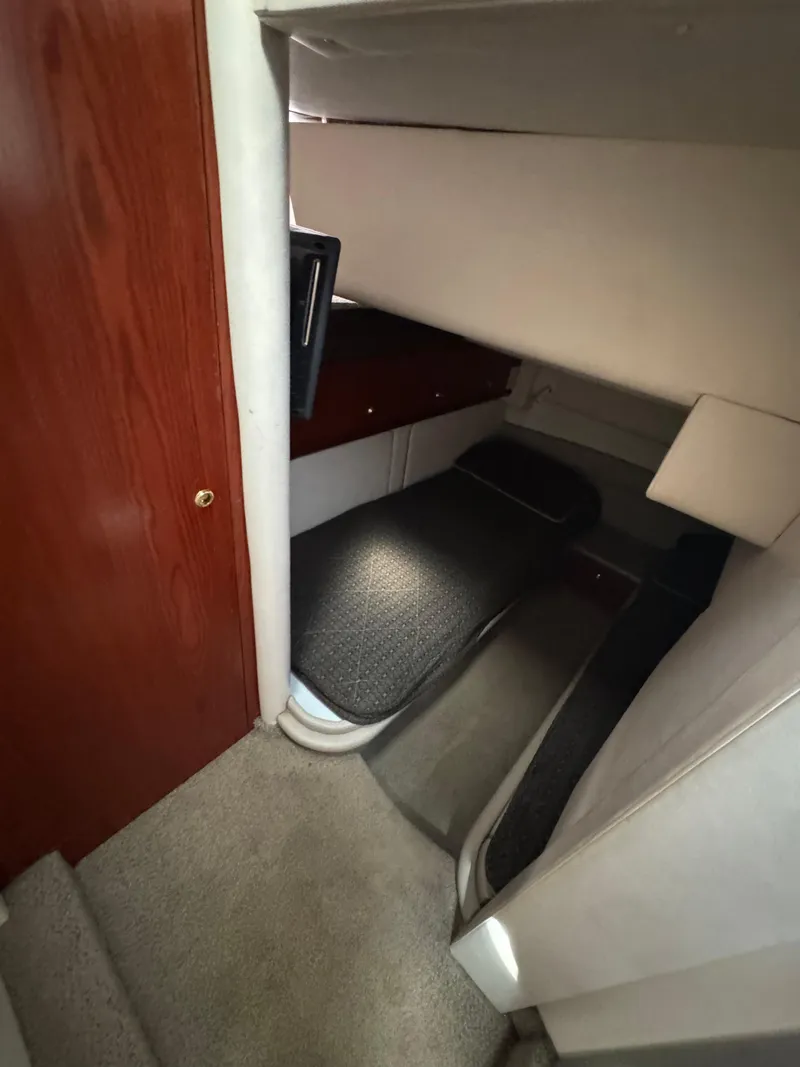 Slide: The Image of Interior cabin of 1998 Maxum 4600 SCB yacht with bed and wooden door. - 24