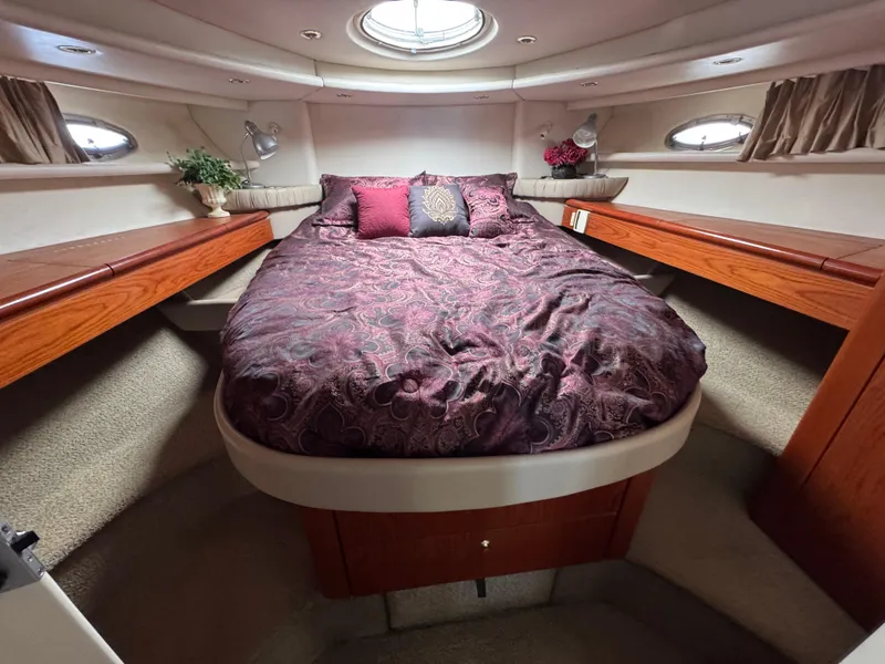 Slide: The Image of Luxurious bedroom interior of 1998 Maxum 4600 SCB yacht with elegant bedding and wood accents. - 29
