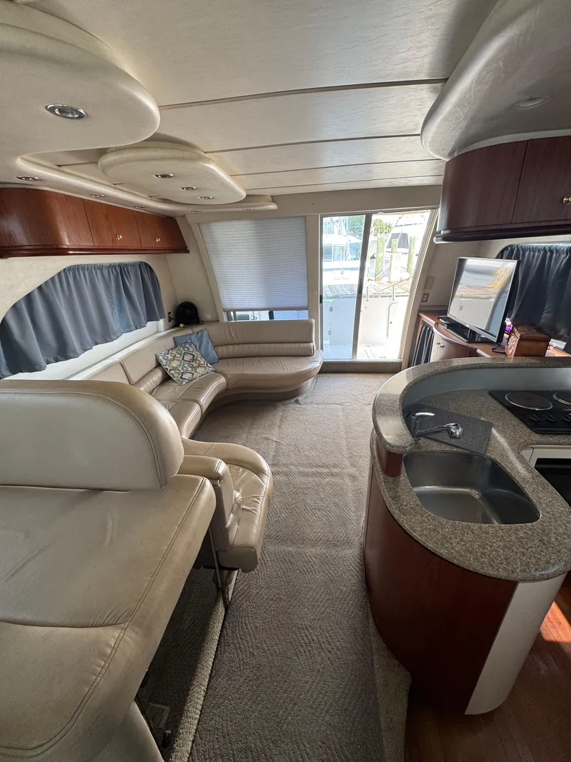 Slide: The Image of Luxurious interior of a 1998 Maxum 4600 SCB yacht with modern furnishings and kitchenette. - 30