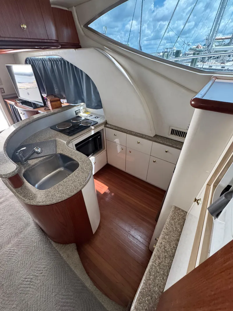 Slide: The Image of Interior of 1998 Maxum 4600 SCB yacht kitchen with sink, stove, and cabinets. - 31