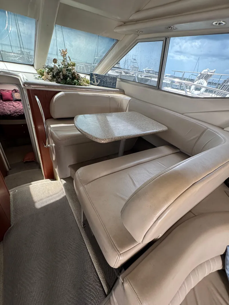 Slide: The Image of Interior of 1998 Maxum 4600 SCB yacht with beige seating and table. - 32