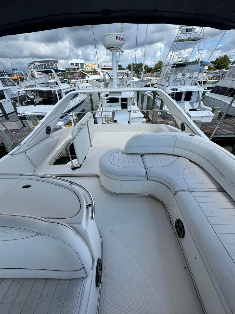 Slide: The Image of 1998 Maxum 4600 SCB yacht with spacious deck and seating at marina. - 8