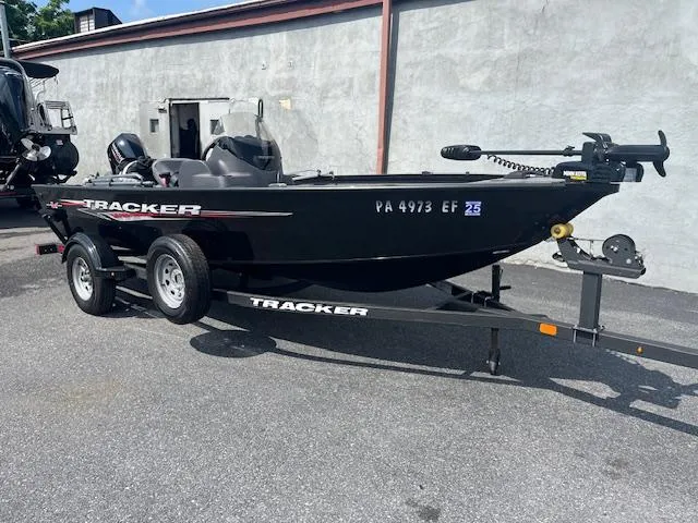 Slide: The Image of 2024 Tracker Super Guide V-16 SC boat on trailer, parked outdoors. - 4
