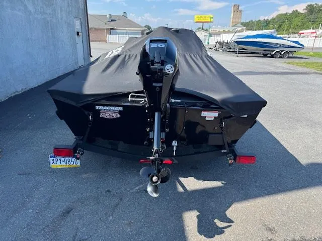 Slide: The Image of 2024 Tracker Super Guide V-16 SC boat with cover, parked outdoors. - 6