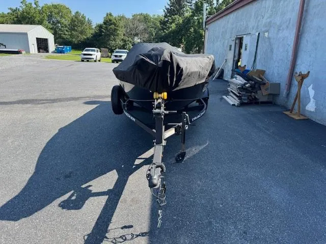 Slide: The Image of 2024 Tracker Super Guide V-16 SC boat covered and parked outdoors. - 8