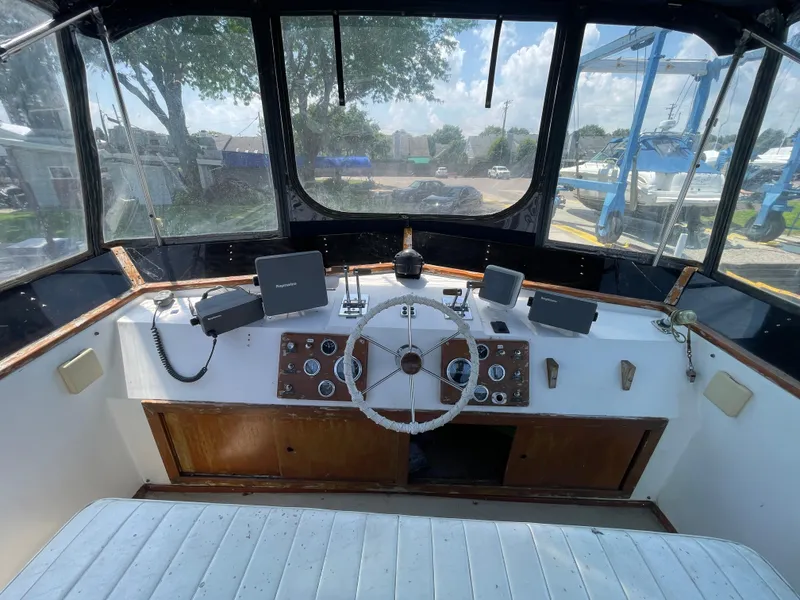 Slide: The Image of 1982 Californian 34 LRC boat helm with steering wheel and navigation equipment. - 15