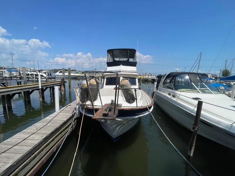 Slide: The Image of 1982 Californian 34 LRC yacht docked at marina under clear blue sky. - 2