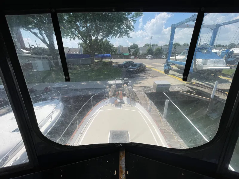 Slide: The Image of View from the helm of a 1982 Californian 34 LRC yacht in a marina. - 24