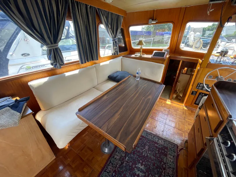 Slide: The Image of Interior of 1982 Californian 34 LRC yacht with cozy seating and wooden table. - 27