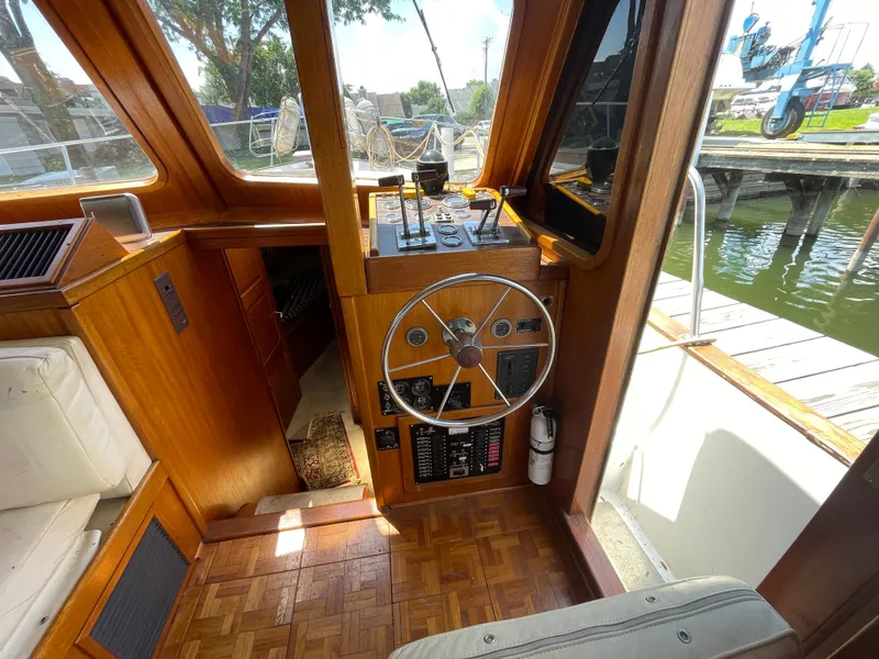 Slide: The Image of 1982 Californian 34 LRC boat helm with wooden interior and steering wheel. - 28