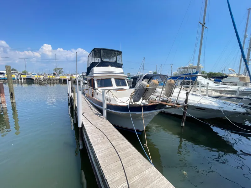 Slide: The Image of 1982 Californian 34 LRC yacht docked at marina under clear blue sky. - 3