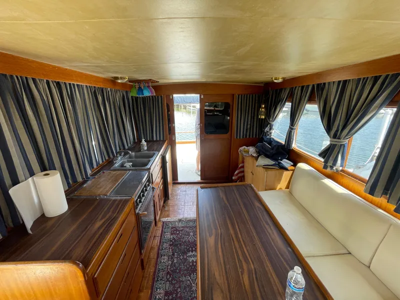 Slide: The Image of Interior of 1982 Californian 34 LRC boat with kitchen and seating area. - 35