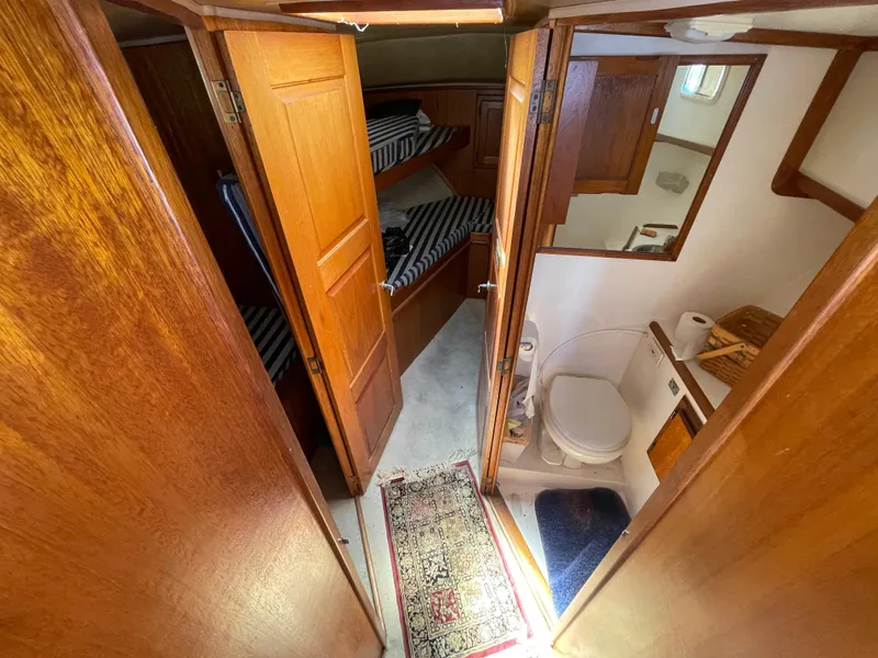 Slide: The Image of Interior of 1982 Californian 34 LRC yacht with wooden doors, bunk beds, and compact bathroom. - 37