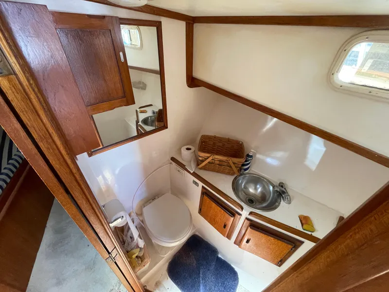 Slide: The Image of 1982 Californian 34 LRC boat bathroom with wooden cabinets, sink, and toilet. - 38