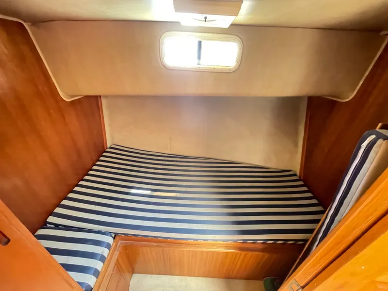 Slide: The Image of 1982 Californian 34 LRC cabin with striped bedding and wooden interior. - 39