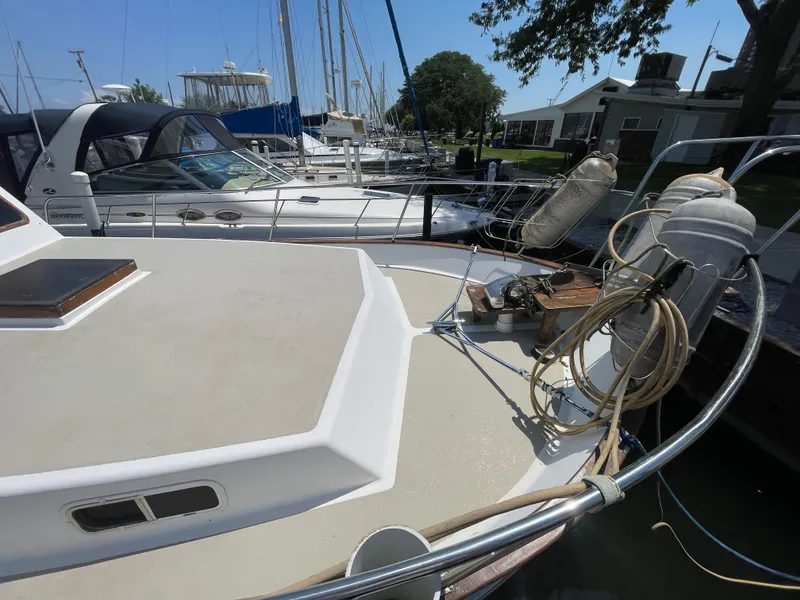 Slide: The Image of 1982 Californian 34 LRC yacht docked at marina, featuring deck and mooring equipment. - 4