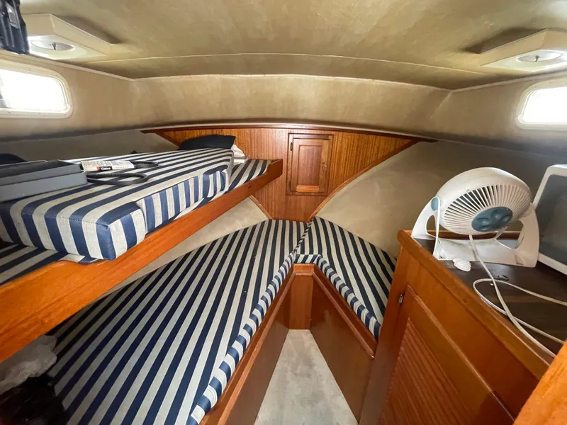 Slide: The Image of Interior of 1982 Californian 34 LRC boat with striped cushions and wooden cabinetry. - 40