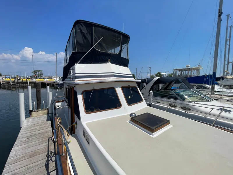 Slide: The Image of 1982 Californian 34 LRC yacht docked at marina under clear blue sky. - 5