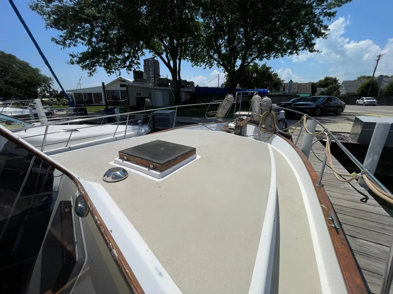 Slide: The Image of 1982 Californian 34 LRC yacht docked, featuring spacious deck and marina surroundings. - 6
