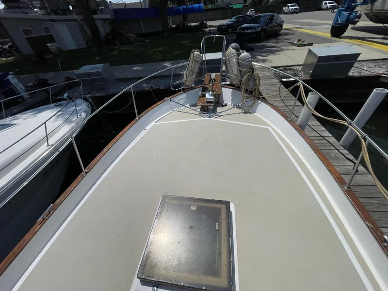 Slide: The Image of 1982 Californian 34 LRC yacht docked at marina, view of bow and deck. - 7