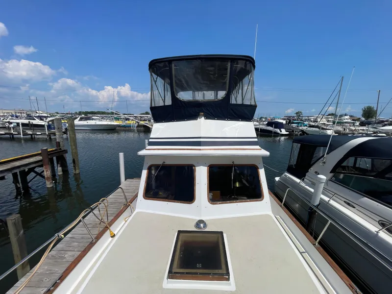 Slide: The Image of 1982 Californian 34 LRC yacht docked at marina under clear blue sky. - 9
