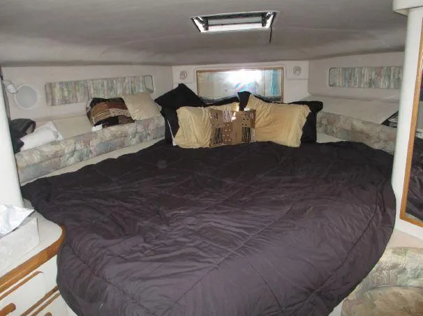 Slide: The Image of Interior cabin of 1994 Sea Ray 500 Sundancer with cozy bedding and pillows. - 12