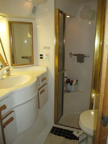 Slide: The Image of Bathroom interior of 1994 Sea Ray 500 Sundancer yacht, featuring shower and vanity. - 13
