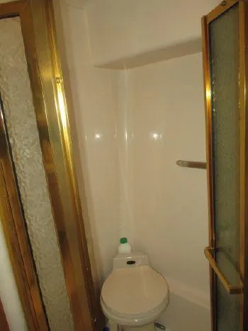 Slide: The Image of Bathroom interior of 1994 Sea Ray 500 Sundancer yacht with gold accents. - 15