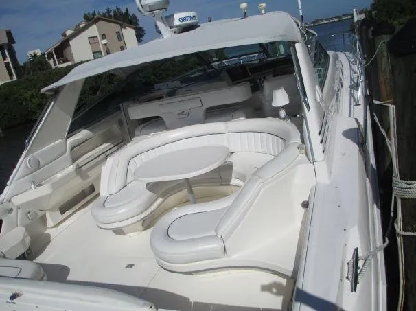 Slide: The Image of 1994 Sea Ray 500 Sundancer yacht with spacious white seating and table on deck. - 2