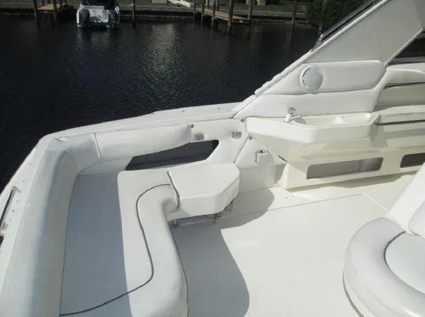Slide: The Image of 1994 Sea Ray 500 Sundancer yacht interior with white seating and water view. - 5