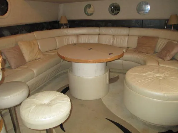 Slide: The Image of Luxurious interior of a 1994 Sea Ray 500 Sundancer yacht with plush seating and round table. - 9