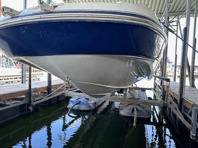 Slide: The Image of 2003 Four Winns 264 Funship boat docked in a marina, viewed from below. - 16