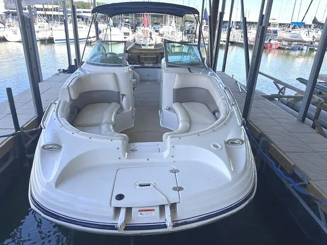 Slide: The Image of 2003 Four Winns 264 Funship boat docked at marina, featuring spacious seating and sleek design. - 5